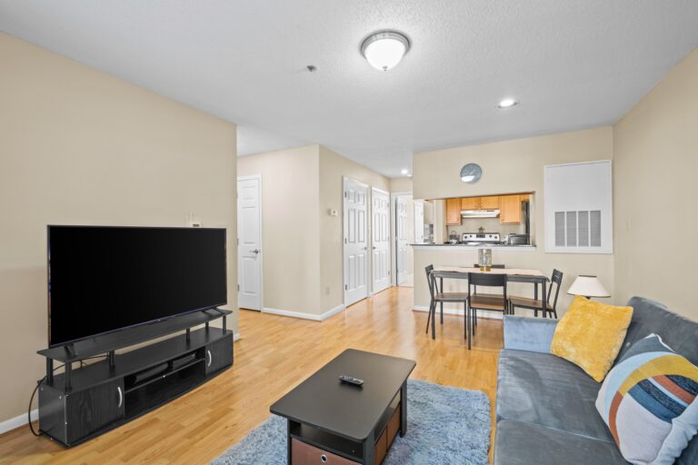 Living room with kitchen in the background.