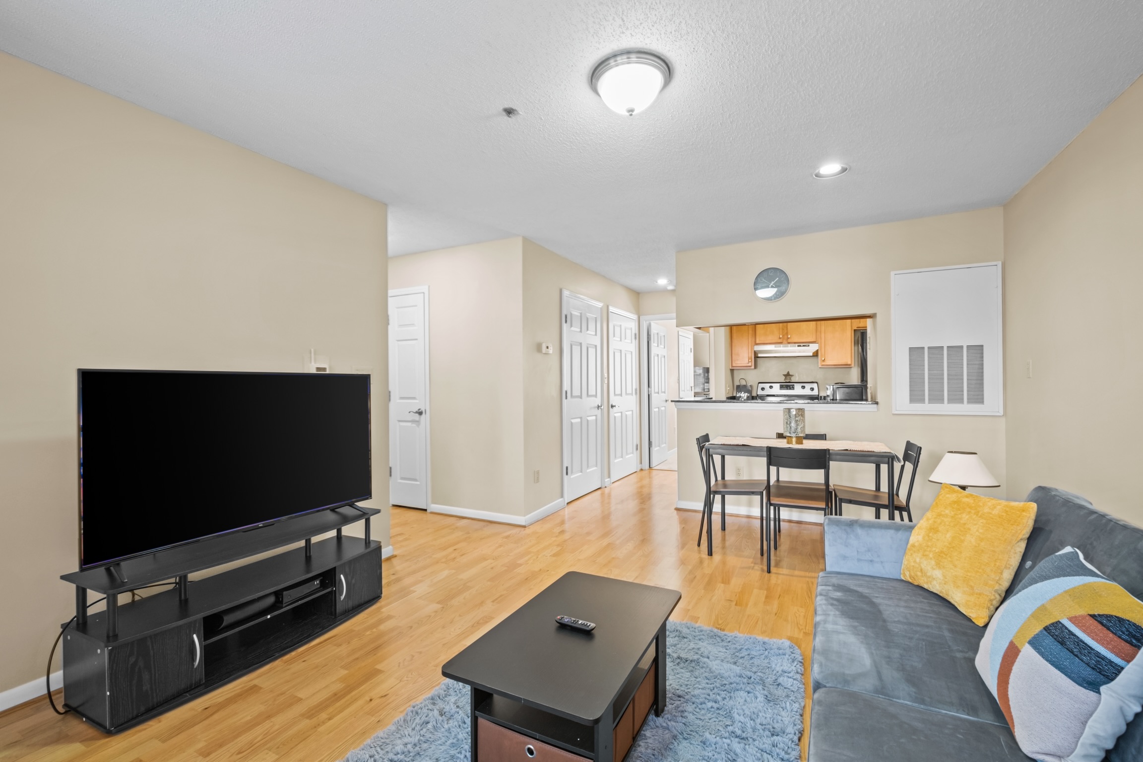Living room with kitchen in the background.